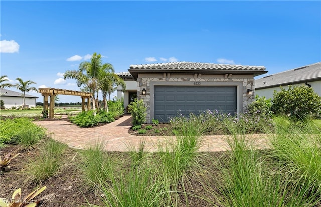 view of front of property with a garage and a pergola