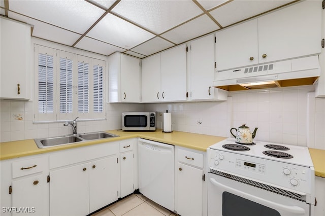 1200 Cherrystone Ct Unit B209, Naples, FL 34102 - kitchen featuring white appliances, under cabinet range hood, a sink, decorative backsplash, and white cabinetry