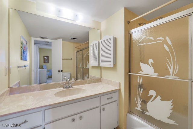 1200 Cherrystone Ct Unit B209, Naples, FL 34102 - bathroom with vanity, toilet, and bath / shower combo with glass door