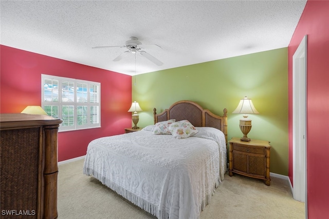 carpeted bedroom with ceiling fan and a textured ceiling