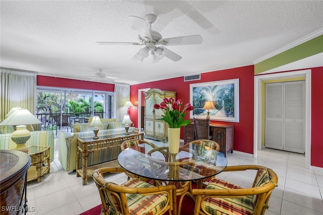 tiled dining room featuring ceiling fan, crown molding, and a textured ceiling