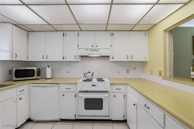 kitchen featuring light tile patterned floors, white appliances, white cabinetry, and backsplash