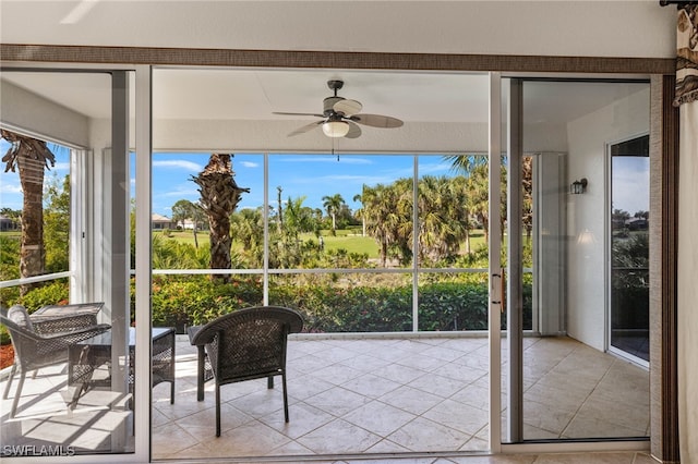 sunroom featuring ceiling fan