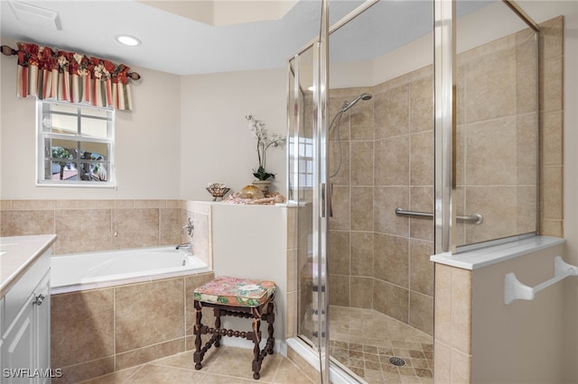 bathroom featuring independent shower and bath, vanity, and tile patterned floors