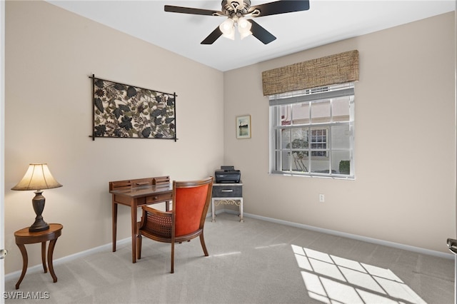 carpeted home office featuring ceiling fan