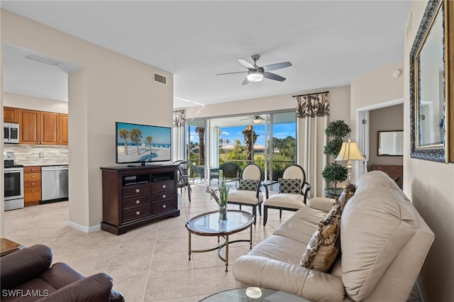 tiled living room with ceiling fan