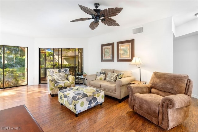 living room featuring ceiling fan and wood-type flooring