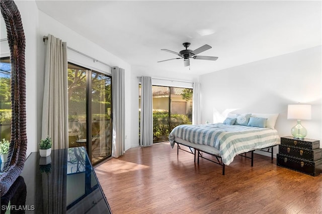 bedroom featuring access to exterior, wood-type flooring, and ceiling fan