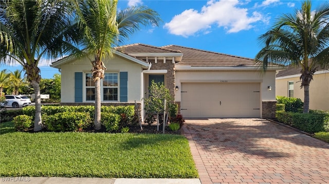 view of front of home with a front yard and a garage