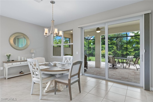 dining area featuring ceiling fan with notable chandelier and light tile patterned floors