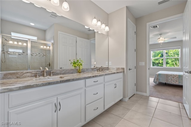 bathroom featuring tile patterned flooring, vanity, ceiling fan, and an enclosed shower