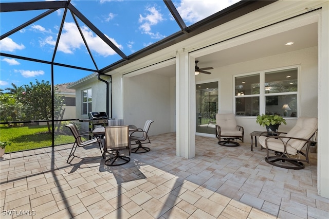 view of patio / terrace with ceiling fan and a lanai