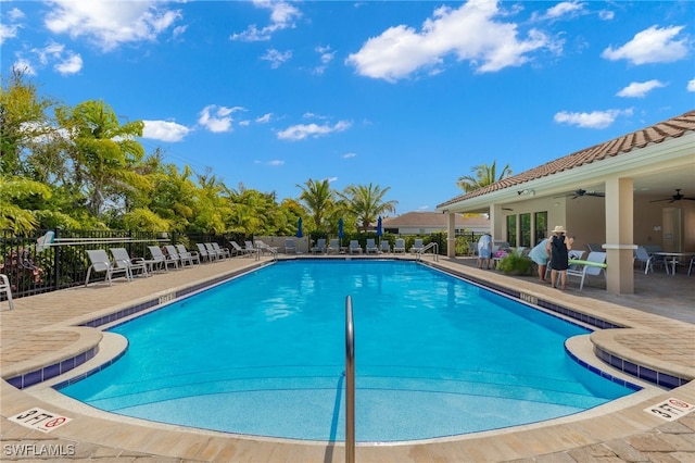 view of swimming pool with a patio and ceiling fan