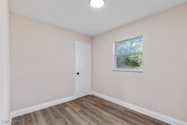 empty room featuring dark hardwood / wood-style flooring