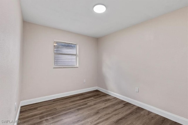 empty room with dark hardwood / wood-style floors