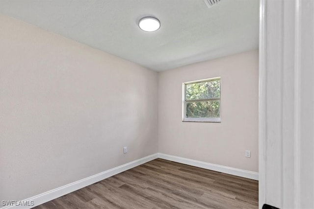 spare room with wood-type flooring