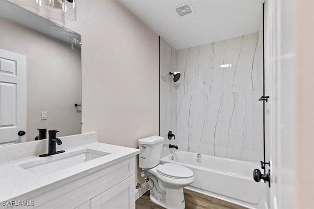 full bathroom with toilet, hardwood / wood-style floors, vanity, and tiled shower / bath combo