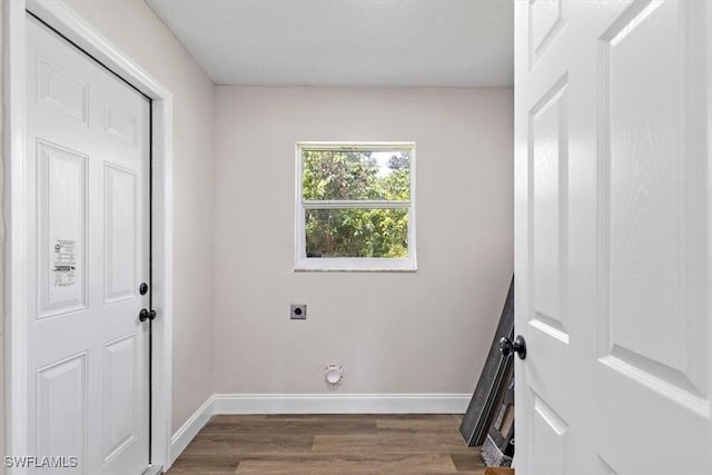 laundry area with hookup for an electric dryer and dark hardwood / wood-style flooring