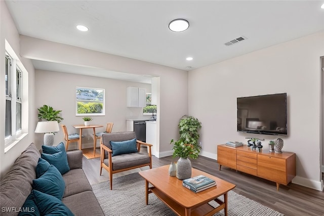 living room with dark hardwood / wood-style flooring