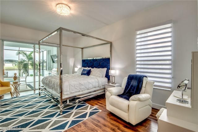 bedroom featuring access to outside and dark hardwood / wood-style floors