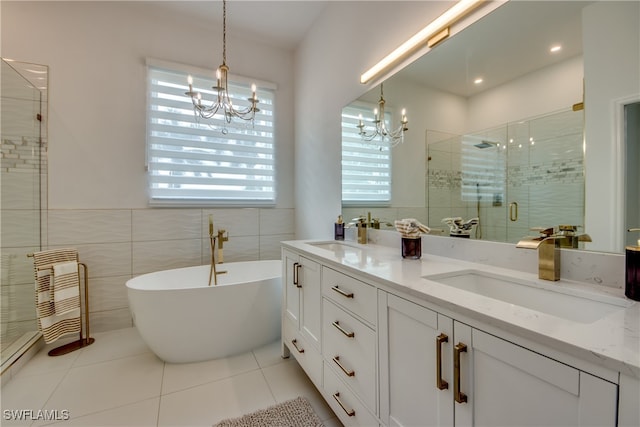 bathroom featuring tile patterned floors, vanity, tile walls, independent shower and bath, and a notable chandelier