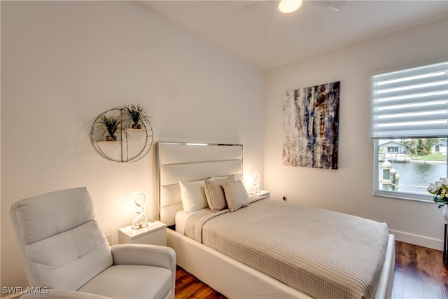 bedroom with ceiling fan and dark wood-type flooring