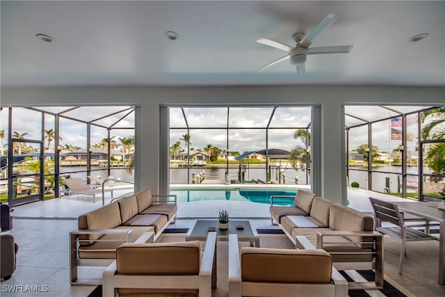 exterior space featuring a water view, plenty of natural light, and ceiling fan