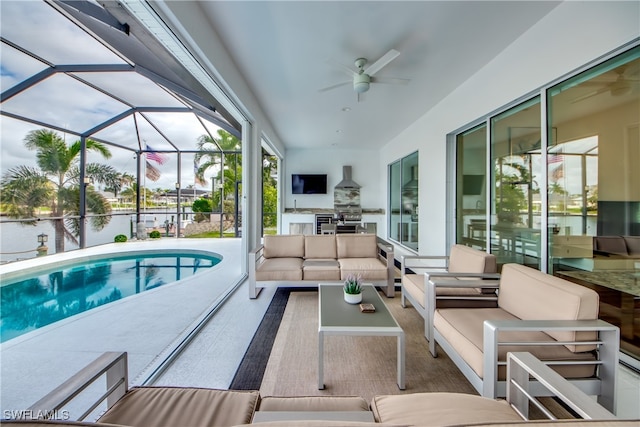 view of swimming pool featuring a patio area, an outdoor living space, ceiling fan, and glass enclosure