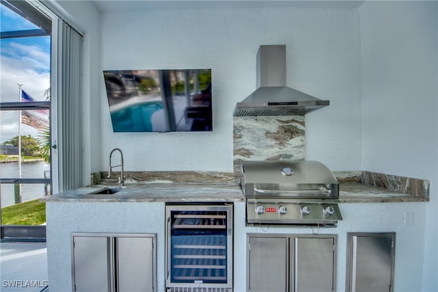 exterior space featuring wine cooler, sink, and wall chimney range hood