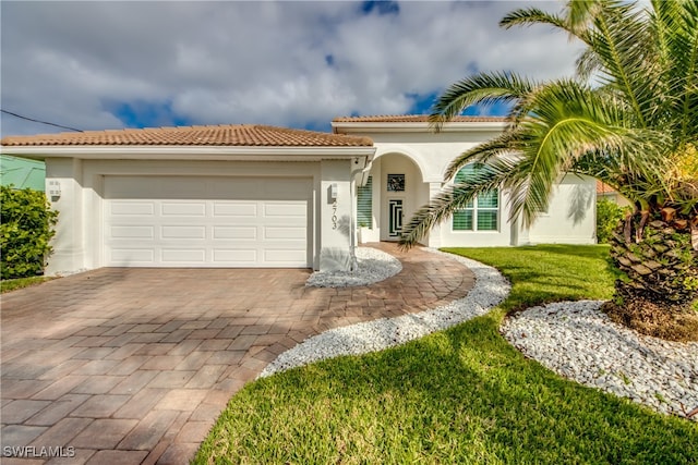 mediterranean / spanish-style home with a garage