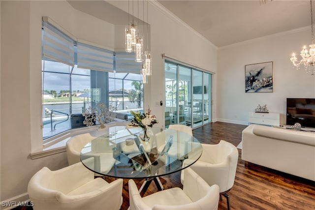 dining room with plenty of natural light, dark hardwood / wood-style floors, ornamental molding, and a chandelier