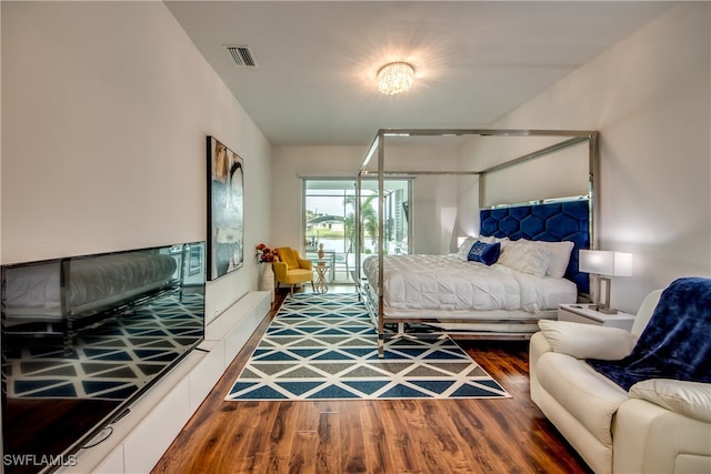 bedroom with dark hardwood / wood-style flooring