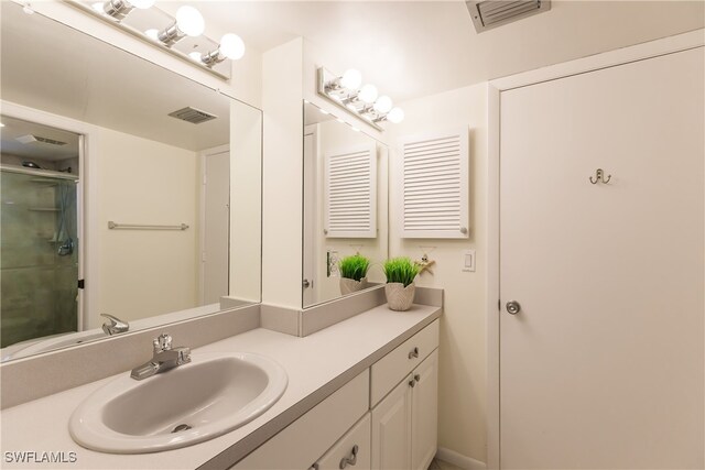 bathroom with vanity and a shower with shower door