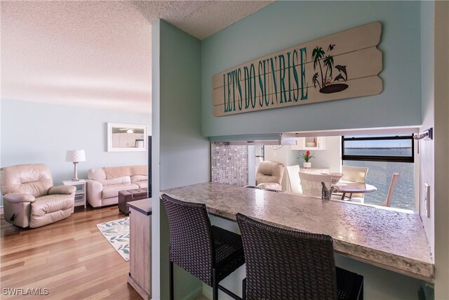 interior space featuring a textured ceiling and light hardwood / wood-style floors