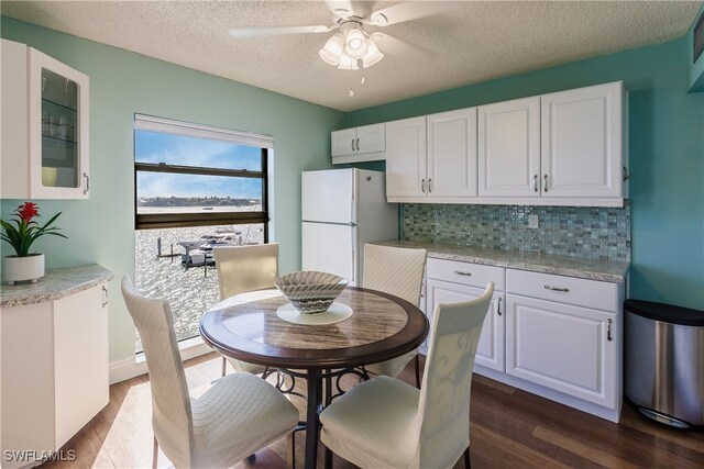 kitchen featuring white cabinets and white refrigerator