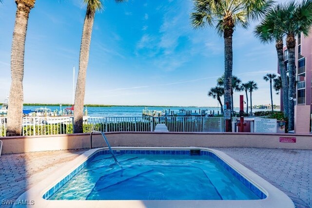 view of swimming pool featuring a water view