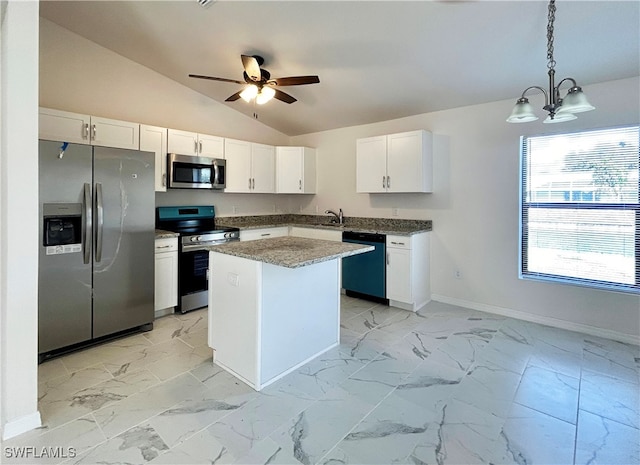 kitchen with appliances with stainless steel finishes, pendant lighting, vaulted ceiling, white cabinets, and a center island