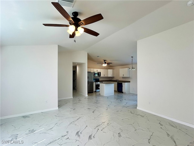 unfurnished living room featuring ceiling fan with notable chandelier and vaulted ceiling