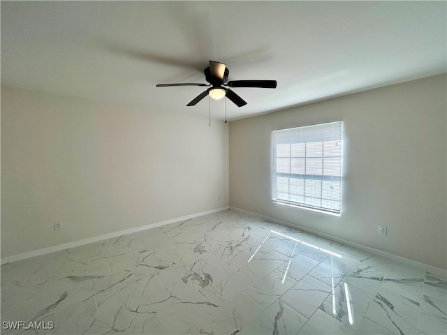 spare room with ceiling fan