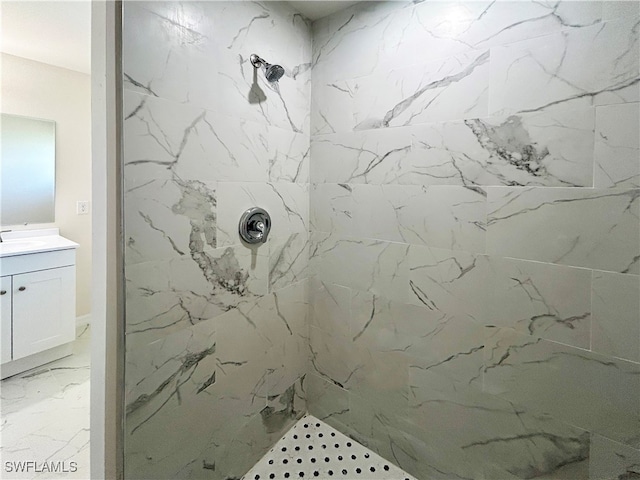 bathroom with vanity and tiled shower