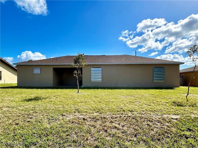 back of house with a lawn