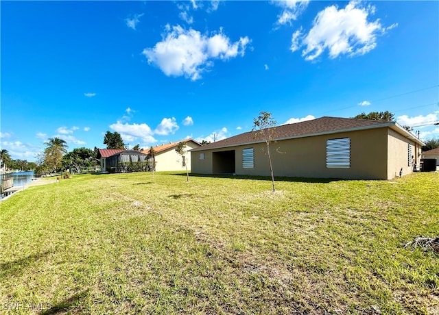 rear view of house featuring a lawn