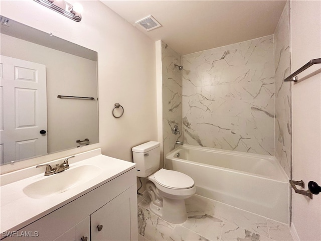 full bathroom featuring vanity, tiled shower / bath combo, and toilet