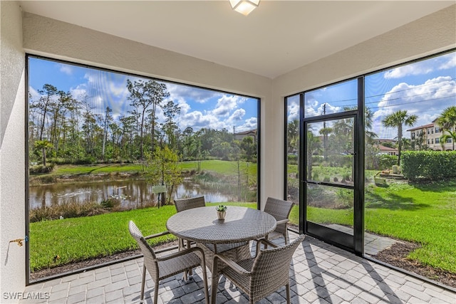 sunroom / solarium with a water view