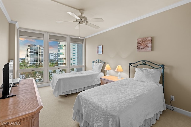 carpeted bedroom featuring a city view, a ceiling fan, ornamental molding, a wall of windows, and baseboards