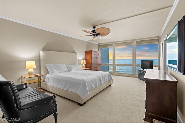 carpeted bedroom with ceiling fan and ornamental molding