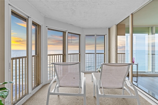 4051 Gulf Shore Blvd N Unit 902, Naples, FL 34103 - sunroom / solarium with a water view, plenty of natural light, and a textured ceiling