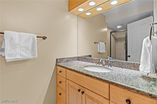 bathroom with vanity, recessed lighting, and a stall shower