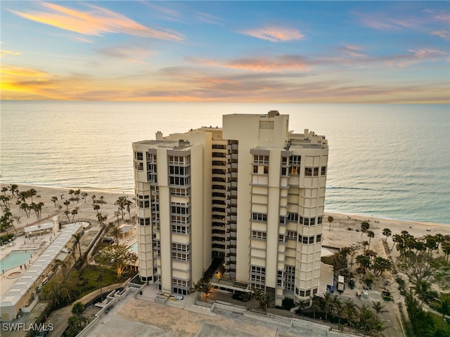 outdoor building at dusk with a view of the beach and a water view