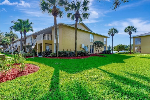 view of side of home with a yard